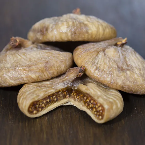 Dried figs, one cut open to show its seeds