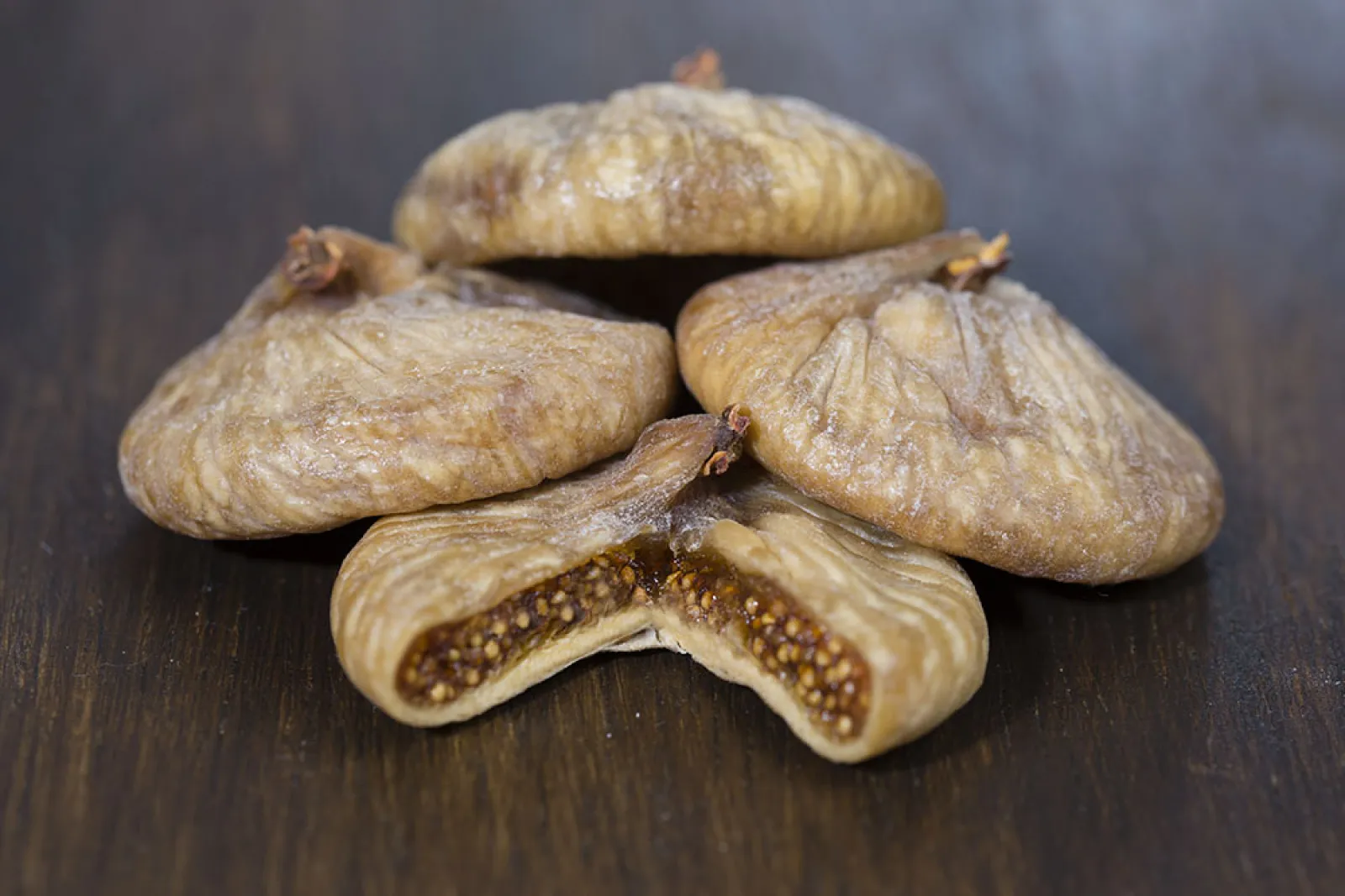 Dried figs, one cut open to show its seeds