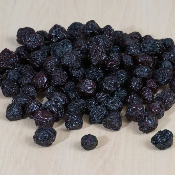 A pile of deep red, almost black dried cherries