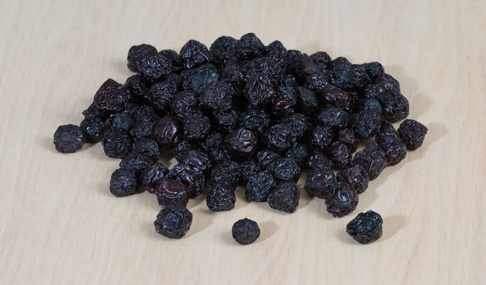 A pile of deep red, almost black dried cherries